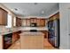 Modern kitchen features stainless steel appliances, granite countertops, and wood cabinets at 25 Kaktovic Ct, Grayson, GA 30017