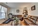 Comfortable living room featuring hardwood floors, a treadmill, and cozy furnishings at 25 Kaktovic Ct, Grayson, GA 30017