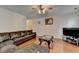 Spacious living room featuring a ceiling fan and large comfortable sectional at 25 Kaktovic Ct, Grayson, GA 30017