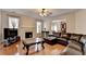 Living room featuring fireplace, hardwood floors, and access to the kitchen at 25 Kaktovic Ct, Grayson, GA 30017