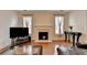 Cozy living room featuring a fireplace with white mantle and large windows at 25 Kaktovic Ct, Grayson, GA 30017