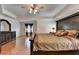 This spacious main bedroom features hardwood floors, a tray ceiling, and a dark wood bedroom set at 25 Kaktovic Ct, Grayson, GA 30017