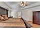 This main bedroom features hardwood floors, a dark wood wardrobe, and natural light at 25 Kaktovic Ct, Grayson, GA 30017
