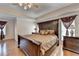 Primary bedroom with hardwood floors, tray ceilings, and neutral decor at 25 Kaktovic Ct, Grayson, GA 30017