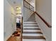 Beautiful staircase with hardwood steps and wrought iron railing at 25 Kaktovic Ct, Grayson, GA 30017