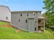 Back exterior view of home featuring a backyard with retaining walls and a deck at 2714 Eagles Crest Ln, Decatur, GA 30034