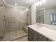 Bathroom featuring a frameless glass shower, double sink vanity with modern fixtures, and tiled floors at 2714 Eagles Crest Ln, Decatur, GA 30034