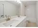 Bright bathroom featuring a double sink vanity with modern faucets, a large mirror, and a shower-tub combo at 2714 Eagles Crest Ln, Decatur, GA 30034