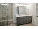 Bathroom featuring a frameless glass shower, double sink vanity with modern fixtures, and tiled floors at 2714 Eagles Crest Ln, Decatur, GA 30034