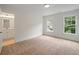 Bright bedroom featuring carpet floors, natural light from two windows, and an ensuite bathroom at 2714 Eagles Crest Ln, Decatur, GA 30034