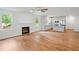 Stylish open-concept space with fireplace, hardwood floors, and white kitchen with stainless steel appliances at 2714 Eagles Crest Ln, Decatur, GA 30034