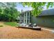 Inviting backyard features a patio with firepit, outdoor seating, and green lawn at 2865 Ivey Oaks Ln, Roswell, GA 30076