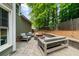 Charming backyard patio featuring an inviting seating area around a cozy fire pit and mature shade trees at 2865 Ivey Oaks Ln, Roswell, GA 30076