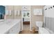 Bright bathroom featuring a vanity with sink, toilet, shower with curtain and a view to the adjacent bedroom at 2865 Ivey Oaks Ln, Roswell, GA 30076