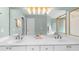 Bright bathroom featuring double sinks, a large mirror with modern lighting and a glass-enclosed shower at 2865 Ivey Oaks Ln, Roswell, GA 30076