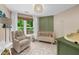 Charming Bedroom features a comfortable armchair, crib, neutral tones, and an abundance of natural light at 2865 Ivey Oaks Ln, Roswell, GA 30076