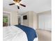This bedroom features plush bedding, a ceiling fan, a television, and a closet for storage at 2865 Ivey Oaks Ln, Roswell, GA 30076