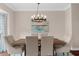 Elegant dining room featuring a modern chandelier, hardwood floors, and neutral decor at 2865 Ivey Oaks Ln, Roswell, GA 30076