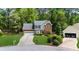 Charming two-story brick and siding home with a well-manicured lawn at 2865 Ivey Oaks Ln, Roswell, GA 30076