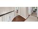 Upstairs hallway with wood floors, carpeted bedrooms, and a decorative light fixture at 2865 Ivey Oaks Ln, Roswell, GA 30076