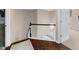 Upstairs hallway with wooden handrail, hard wood floors, and carpeted bedrooms at 2865 Ivey Oaks Ln, Roswell, GA 30076