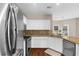 Kitchen featuring stainless steel appliances, granite countertops and backsplash, and white cabinets at 2865 Ivey Oaks Ln, Roswell, GA 30076