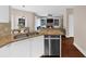 Open floor plan showing the kitchen and living room that features updated appliances and cozy fireplace at 2865 Ivey Oaks Ln, Roswell, GA 30076