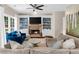 Cozy living room with a fireplace, built-in shelving, and a large window to the exterior at 2865 Ivey Oaks Ln, Roswell, GA 30076