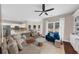 Open-concept living room featuring a large sectional couch, windows, and an adjacent kitchen at 2865 Ivey Oaks Ln, Roswell, GA 30076