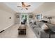 Spacious bonus room featuring a comfortable sofa, coffee table, TV, and a large window for ample natural light at 2865 Ivey Oaks Ln, Roswell, GA 30076