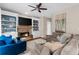 Relaxing living room featuring a fireplace, a large TV, built-in shelves, and comfortable seating at 2865 Ivey Oaks Ln, Roswell, GA 30076