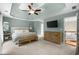 Spacious bedroom with a tray ceiling, ceiling fan, and large dresser at 2865 Ivey Oaks Ln, Roswell, GA 30076