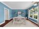 Stylish office with large window, hardwood floors, blue walls, and contemporary furniture at 2865 Ivey Oaks Ln, Roswell, GA 30076