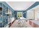 Bright home office with built-in shelving, a large window, hardwood floors, and a modern white desk at 2865 Ivey Oaks Ln, Roswell, GA 30076