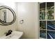 Bathroom featuring modern fixtures, a decorative mirror and bright window at 600 Ponderosa Ct, Fayetteville, GA 30214
