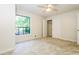 Bright carpeted bedroom with a ceiling fan and a view from the window and a closet at 600 Ponderosa Ct, Fayetteville, GA 30214
