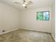 Bright carpeted bedroom with a ceiling fan and a large window showing the green outdoors at 600 Ponderosa Ct, Fayetteville, GA 30214