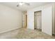Bright carpeted bedroom with a ceiling fan and an open closet in the corner at 600 Ponderosa Ct, Fayetteville, GA 30214
