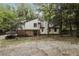 Charming two-story home with a brick accent and surrounded by mature trees and lush greenery at 600 Ponderosa Ct, Fayetteville, GA 30214