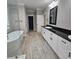 Stylish bathroom showcasing a dual sink vanity, granite counters, and a glass-enclosed shower at 6093 Wayarer Dr, Villa Rica, GA 30180