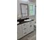 Bathroom featuring modern vanity with black hardware, sleek countertop, and a large mirror at 6093 Wayarer Dr, Villa Rica, GA 30180