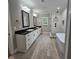 Modern bathroom with double vanity, granite countertop, glass shower, and soaking tub at 6093 Wayarer Dr, Villa Rica, GA 30180