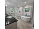 Bright bathroom boasts a soaking tub, subway tile shower, granite counters, and dual sinks at 6093 Wayarer Dr, Villa Rica, GA 30180