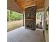 Relaxing outdoor covered patio complete with stone fireplace and ceiling fan at 6093 Wayarer Dr, Villa Rica, GA 30180