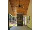Inviting covered patio featuring a stone fireplace and wood ceiling with fan at 6093 Wayarer Dr, Villa Rica, GA 30180
