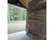 Covered patio with stone fireplace perfect for outdoor entertaining at 6093 Wayarer Dr, Villa Rica, GA 30180