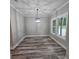 Bright dining room with wood-look floors, modern light fixture, and backyard view at 6093 Wayarer Dr, Villa Rica, GA 30180