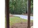 View of a winding driveway through a beautiful landscape of trees at 6093 Wayarer Dr, Villa Rica, GA 30180