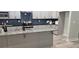 Modern kitchen featuring gray cabinets, granite countertops, stainless steel appliances, and an island at 6093 Wayarer Dr, Villa Rica, GA 30180