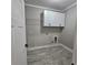 Well-equipped laundry room featuring cabinetry for storage and wood-look floors at 6093 Wayarer Dr, Villa Rica, GA 30180
